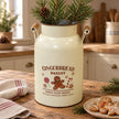 Cream Gingerbread Bakery urn with wooden handles and pine stems on an oak kitchen worktop beside gingerbread biscuits