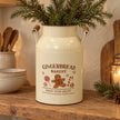 Cream Gingerbread Bakery urn holding pine stems on a rustic oak kitchen shelf