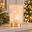 Cream and gold light-up LED glass lantern for home decor, featuring a festive design perfect for holiday mantels.