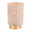 Cream and gold LED glass lantern used as elegant home decor, illuminated with a warm light in a white studio setting.