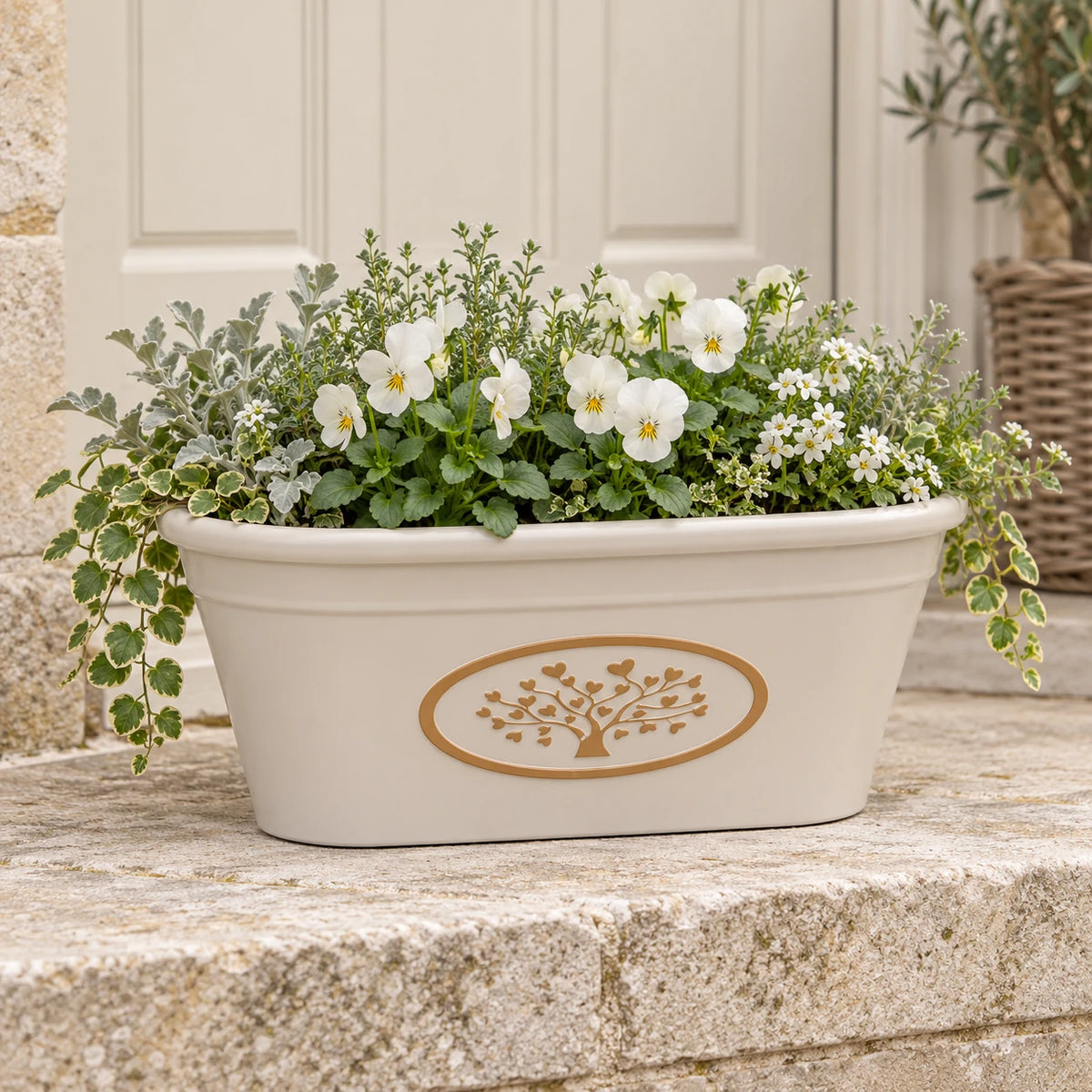 Cream oval planter pot filled with white violas and muted foliage on a cottage porch step.