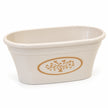 Close-up of the cream oval planter showing its rounded rim, opening and moulded upper edge.