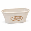 Cream oval recycled plastic planter pot with warm taupe heart-tree medallion, shown empty on white.