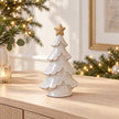 Satchville medium glazed ceramic Christmas tree with cream star topper on console table