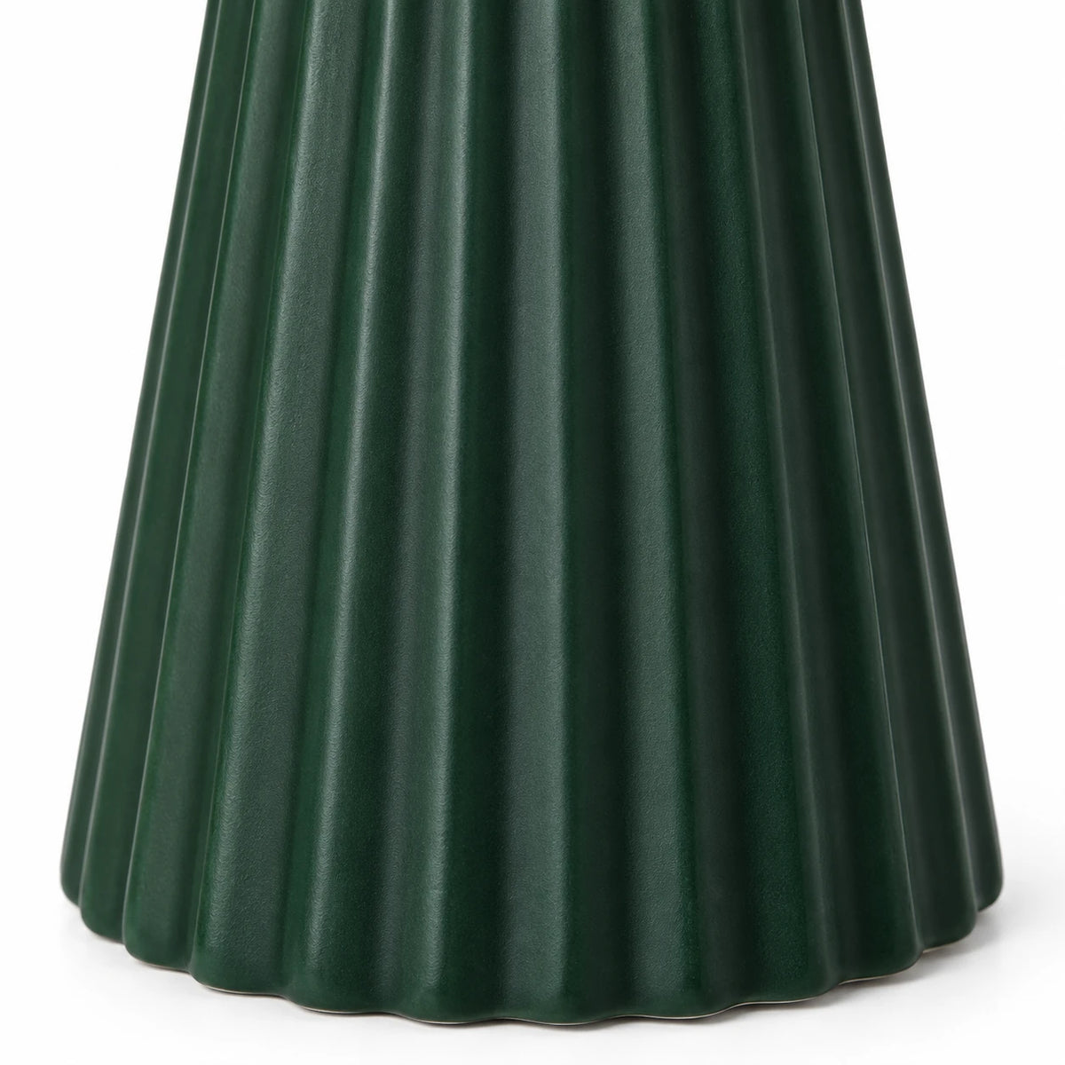 Close-up of vertical ribs and scalloped base on the dark green ceramic Christmas tree