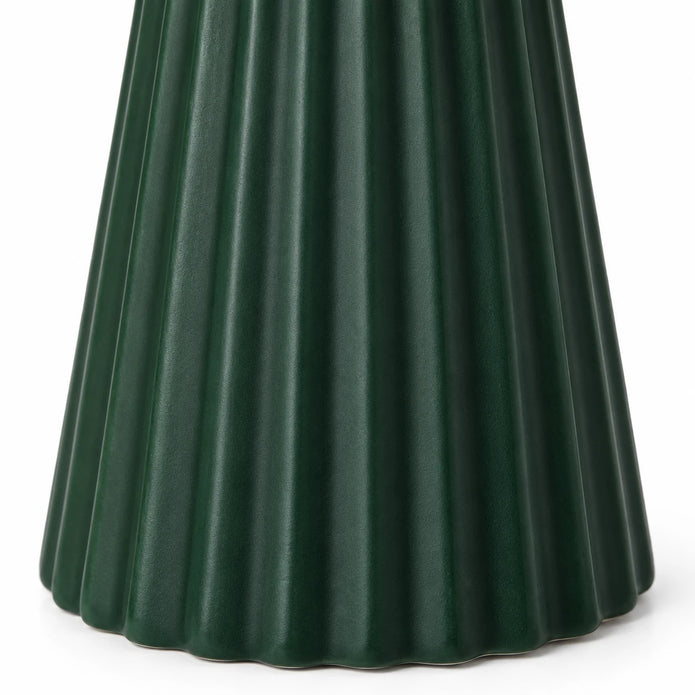 Close-up of vertical ribs and scalloped base on the dark green ceramic Christmas tree