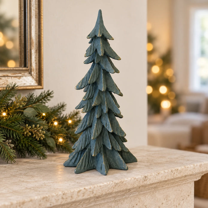 Tall dark sage gold-edged resin tree on a limestone Christmas mantel.