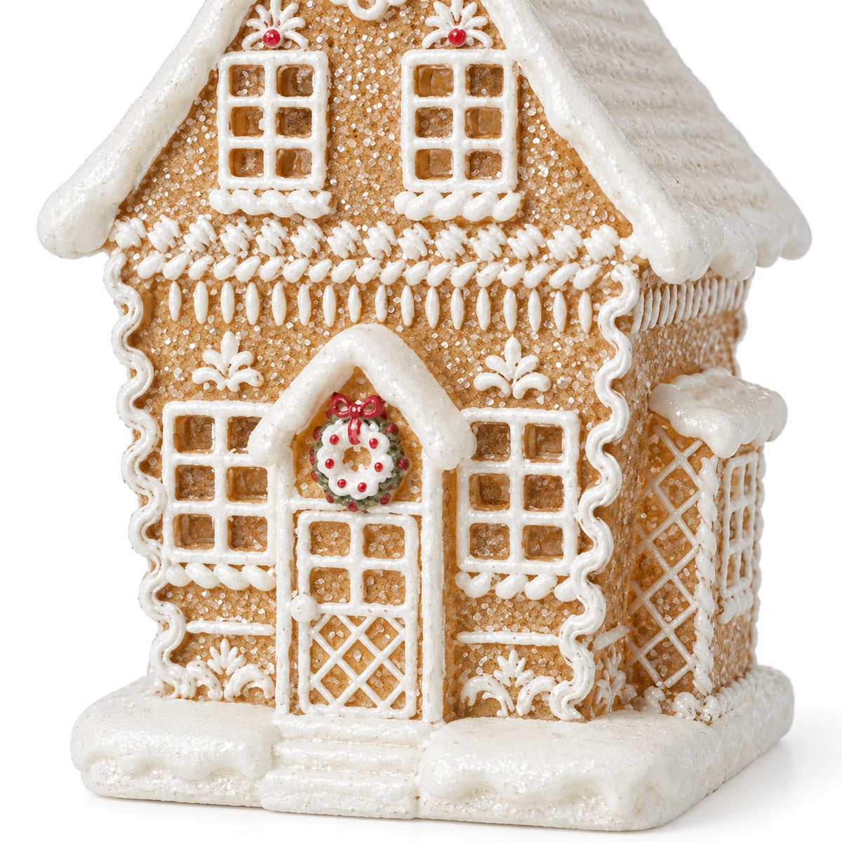 Close-up of the gingerbread house wreath doorway, icing lattice and snowy base