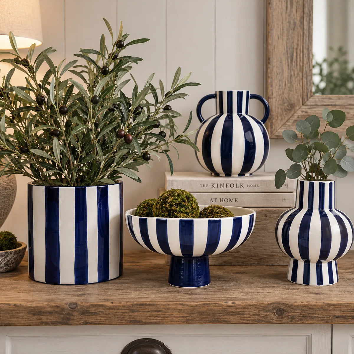 Blue and white striped ceramic collection with two vases, a footed bowl and a cylindrical planter