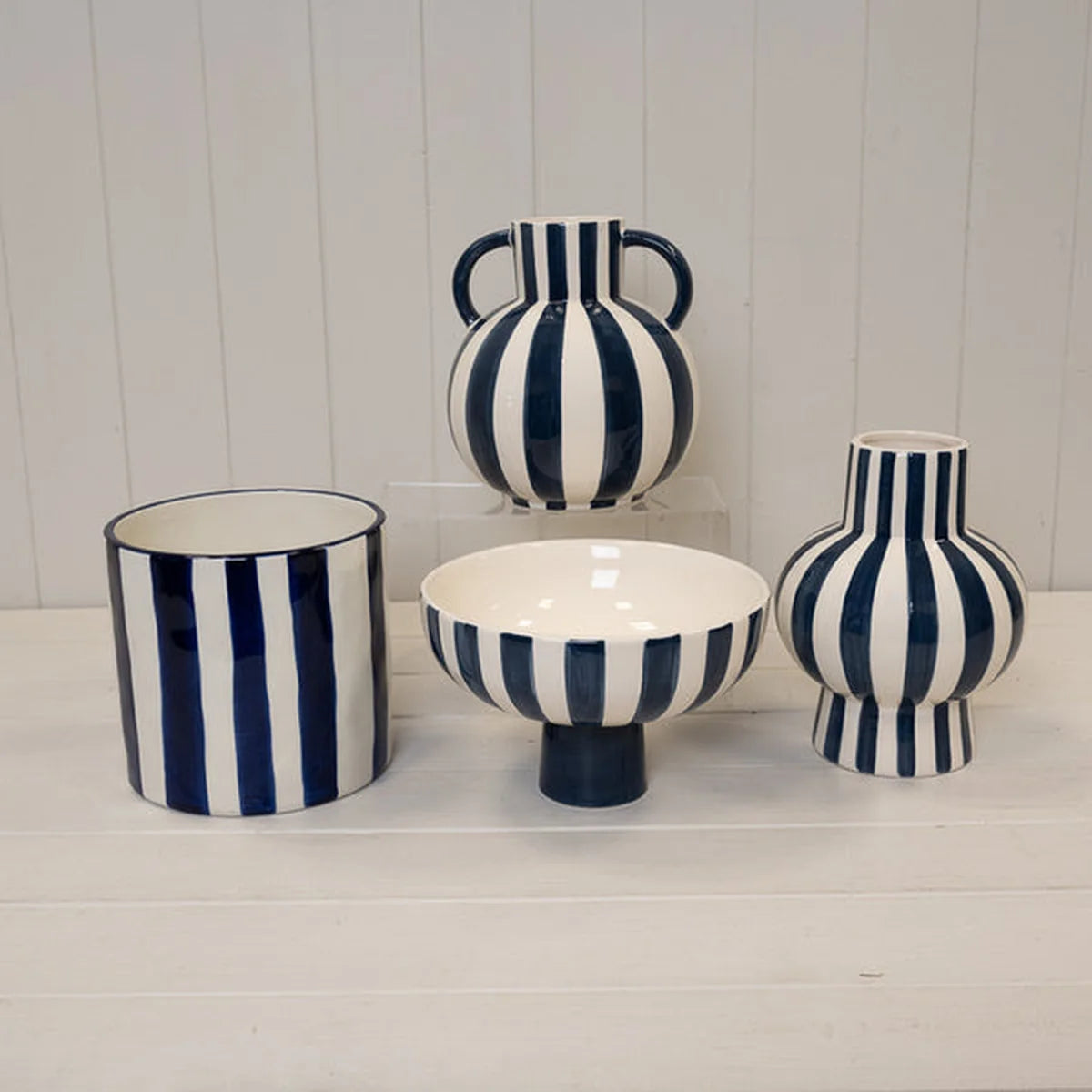 Deep blue and white striped ceramic planter pot by Satchville, round shape with a stylish, modern design for plants.