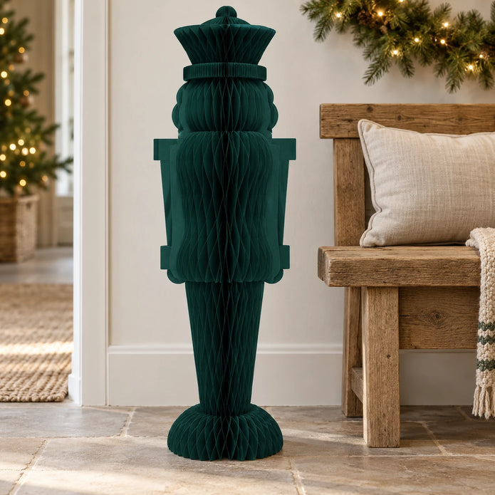 One-metre deep green paper nutcracker beside an oak bench for scale