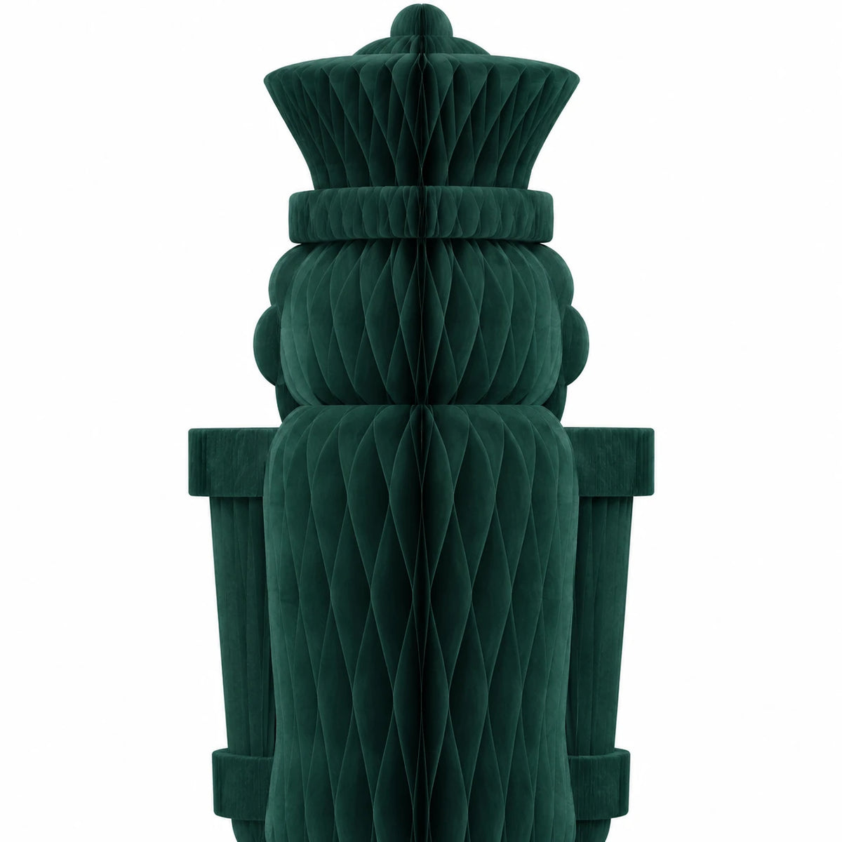 Close-up of the deep green nutcracker's folded paper hat and upper body