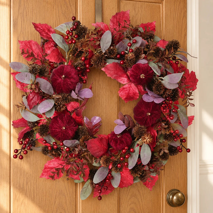 Deep red foliage and pumpkin Christmas wreath by Heaven Sends, styled for holiday decor with autumnal accents.
