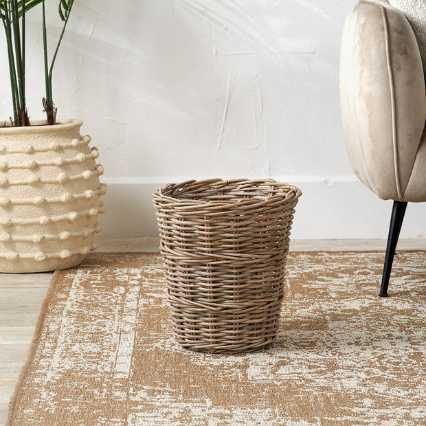 Round waste paper bin made of rattan by Pacific Lifestyle Limited, designed as a stylish basket for office or home use.