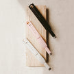 Electric Rechargeable Candle Lighter - White, white, pink and black candle lighters on a wooden board