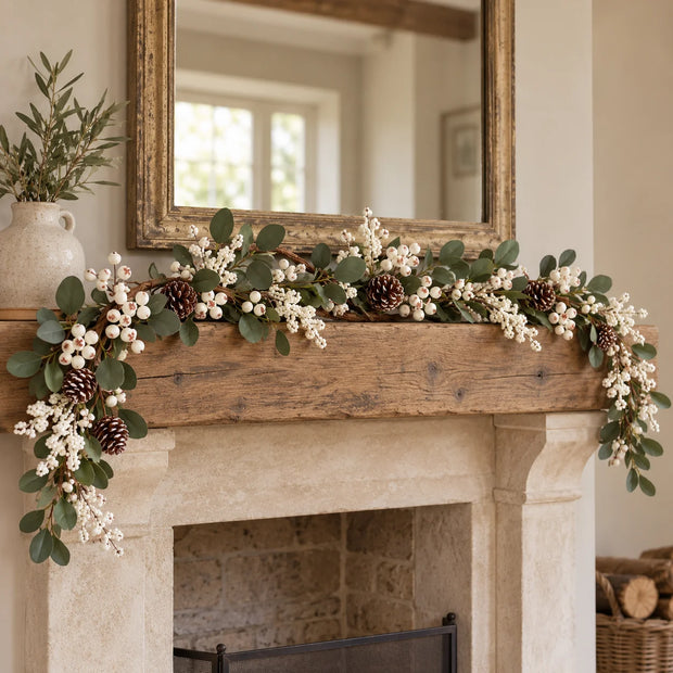 White berry and foliage garland across a mantel