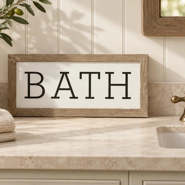 Framed rustic oak BATH sign on a bathroom countertop