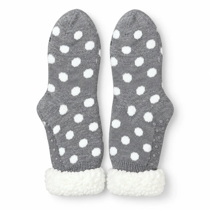 Pair of grey and white spot fleece-lined slipper socks on white