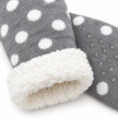 Close-up of grey spotted slipper sock knit, fleece lining and grip sole