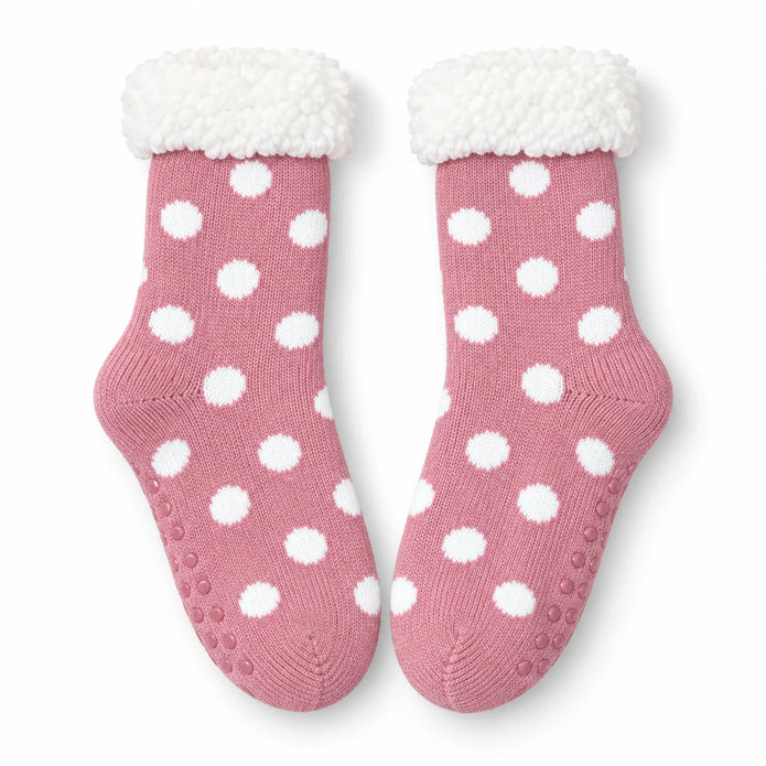 Pair of pink and white spot fleece-lined slipper socks on white