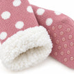 Close-up of pink spotted slipper sock knit, fleece lining and grip sole