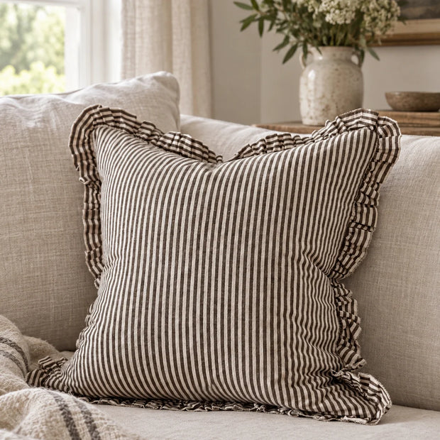 Darcy chocolate brown and white pinstripe 45cm cushion cover styled on a neutral sofa