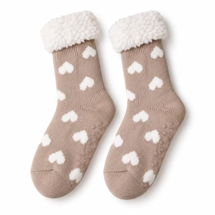 Pair of taupe and white heart fleece-lined slipper socks on white