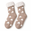 Pair of taupe and white heart fleece-lined slipper socks on white