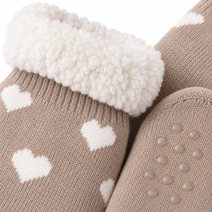 Close-up of taupe heart slipper sock knit, fleece lining and grip sole