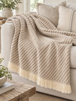 Beige striped Ellenvale Trade soft throw blanket with a cozy, textured appearance, perfect for home decor and comfort.
