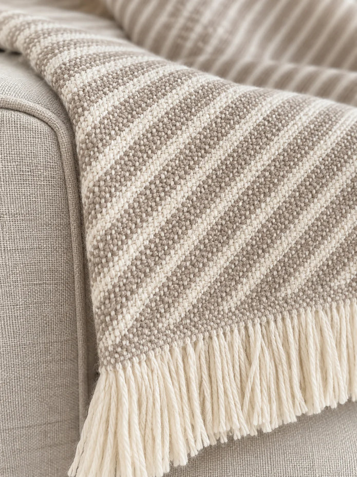 Ellenvale beige striped throw blanket from Ellenvale Trade, soft furnishings with cozy beige and white stripes, perfect for relaxing.