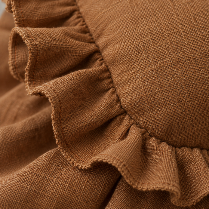 Rust brown Ellenvale Hallie linen blend cushion cover with frilled edges, perfect for soft furnishings and home decor.