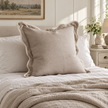 Chloe beige and cream 65 × 65 cm extra large bed cushion cover – styled on a bed, view 1