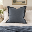 Chloe blue extra large 65 × 65 cm square bed cushion cover – styled upright against pillows on a king bed