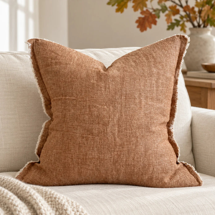 Ellenvale Esmee washed rust brown cushion cover on a sofa, showcasing its soft furnishings design