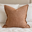 Ellenvale Esmee washed rust brown cushion cover styled on a bedroom bed