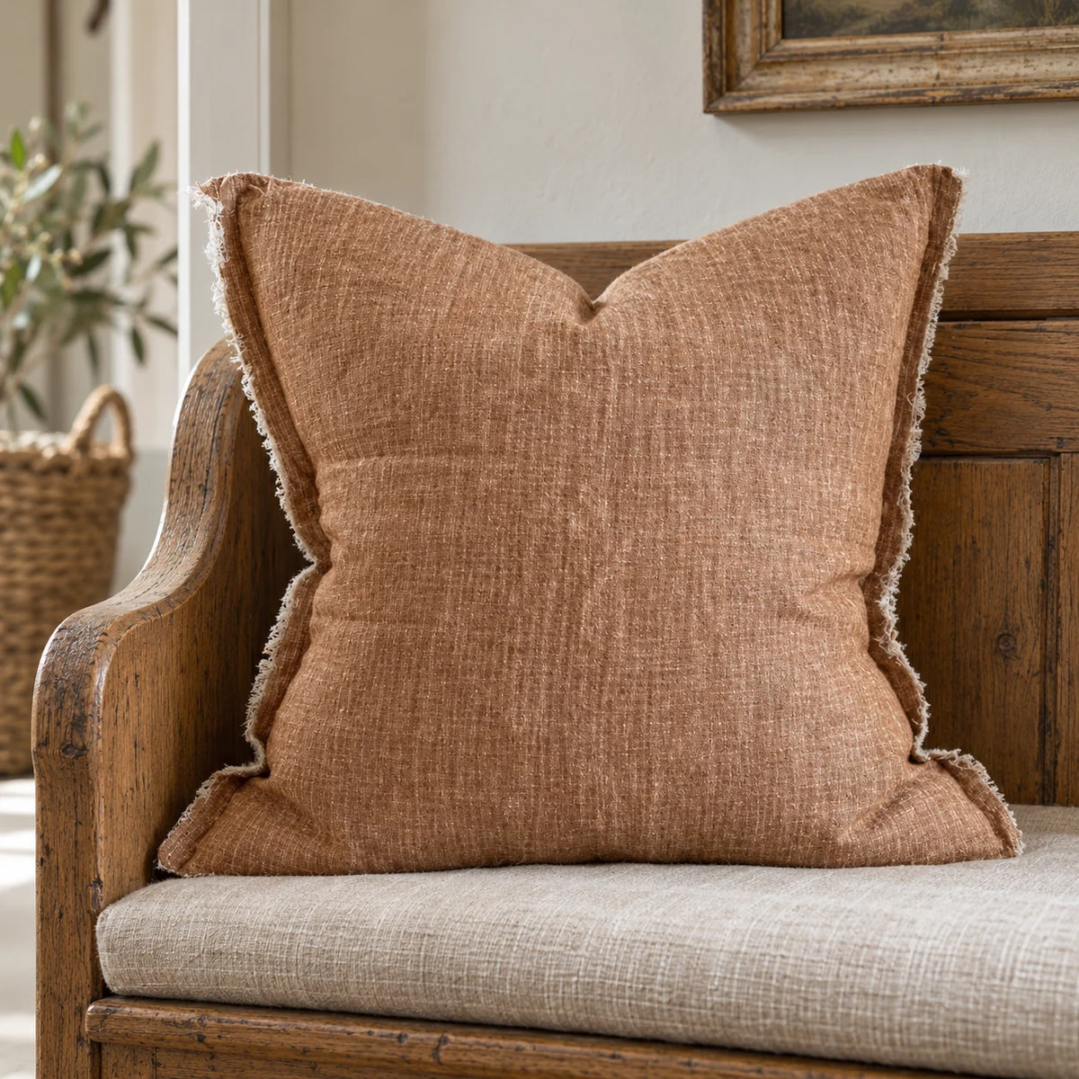 Ellenvale Esmee washed rust brown cushion cover displayed on a country bench