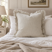 Hallie natural beige 65 × 65 cm extra large bed cushion cover – styled on a bed, view 1