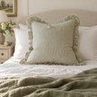 Hallie olive green 65 × 65 cm extra large bed cushion cover – styled on a bed, view 1