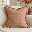 Ellenvale Hallie washed rust brown square cushion cover on a sofa