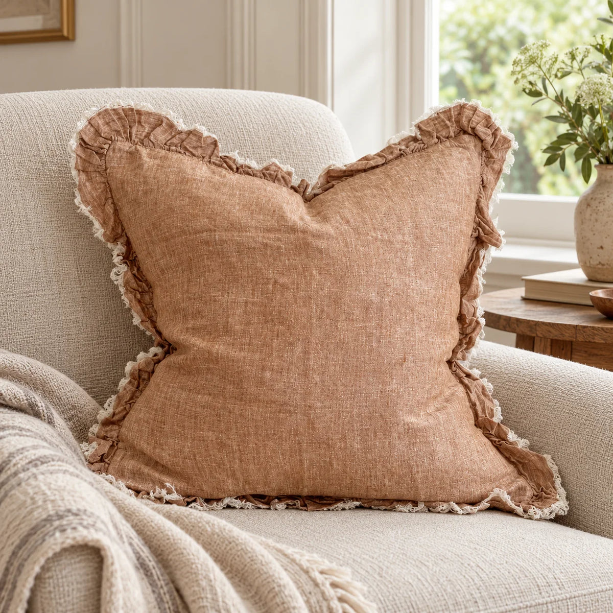 Ellenvale Hallie washed rust brown square cushion cover on an armchair