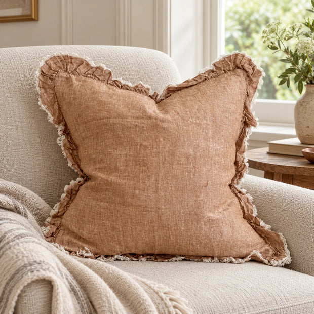 Ellenvale Hallie washed rust brown square cushion cover on an armchair
