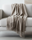 Beige and brown fine knit tasseled throw blanket from Ellenvale Trade, soft furnishings for cozy home decor.