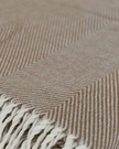 Beige herringbone brown tasseled throw blanket from Ellenvale Trade, soft furnishings with tassel details and textured pattern.