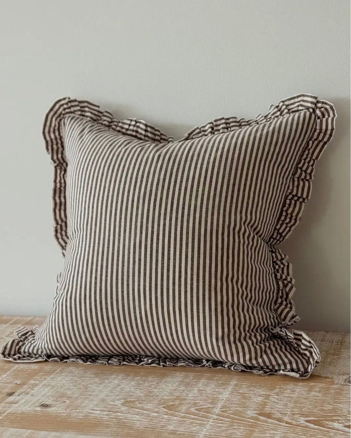 Dark brown Darcy cushion cover with white pinstripes and ruffle detailing, made from luxury cotton blend, designed for soft furnishings.