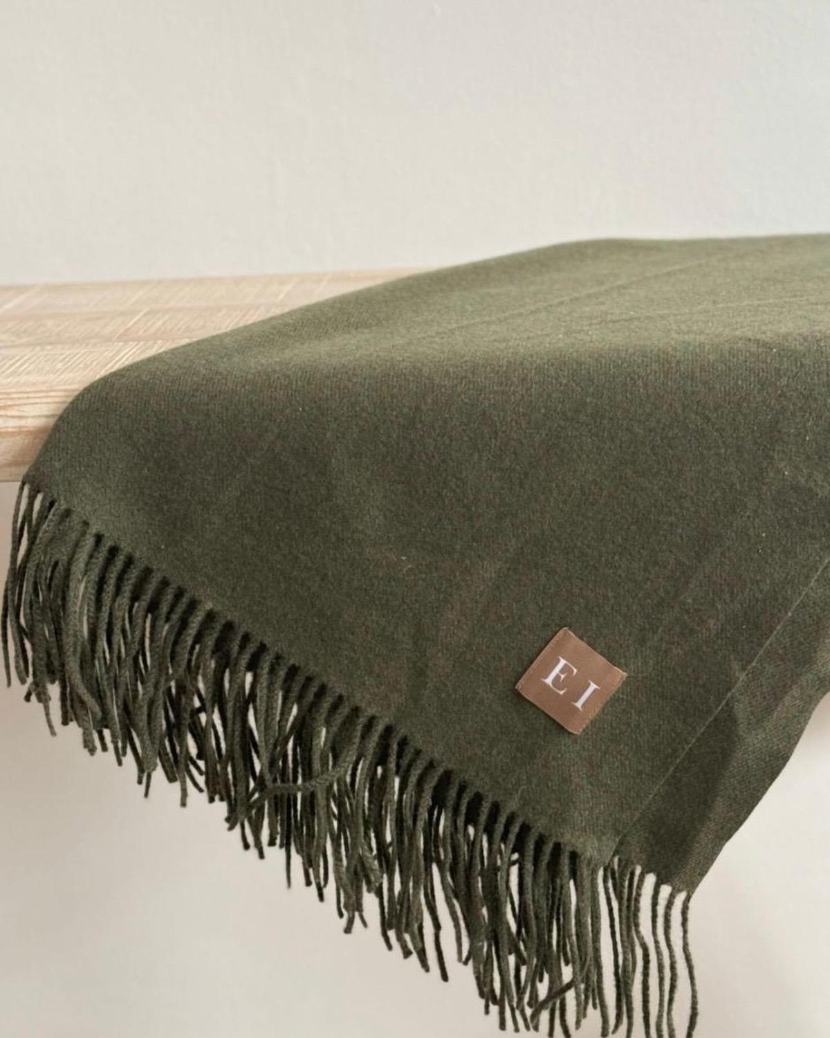 Olive green Della fine knit tasselled throw blanket by Ellenvale Trade, soft furnishings for cozy home decor.