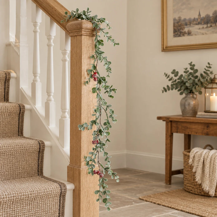 Eucalyptus And Red Berry Garland on an oak stair rail.