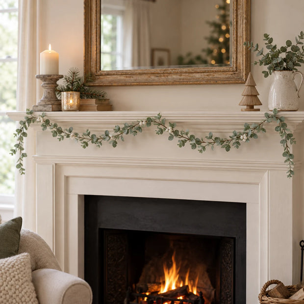 Eucalyptus Leaf And White Berry Garland draped along a cream mantel.
