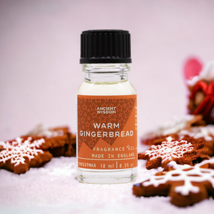 Ancient Wisdom Warm Gingerbread Fragrance Oil 10ml for Christmas, with gingerbread cookies and festive decorations in a glass bottle