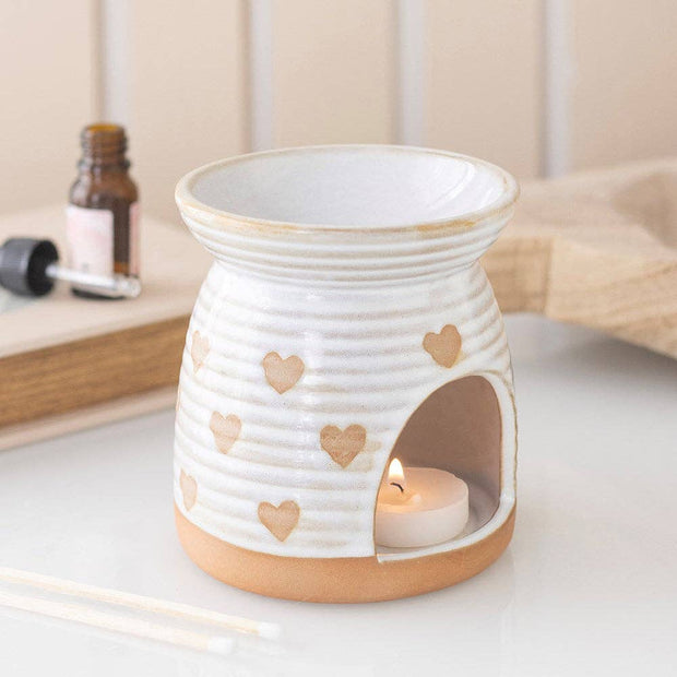 White And Beige Heart Print Oil Burner, white ribbed burner with beige hearts and a lit tealight